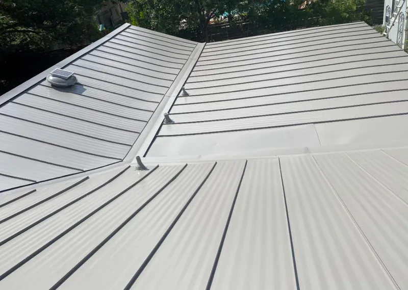 Solar attic fan installed on a metal roof for Roof Ventilation in Duluth