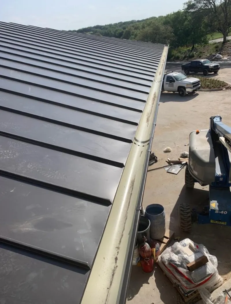 Standing seam panel and gutter detail on a metal roofing jobsite in Duluth